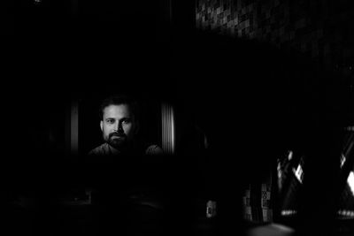 Portrait of man in darkroom