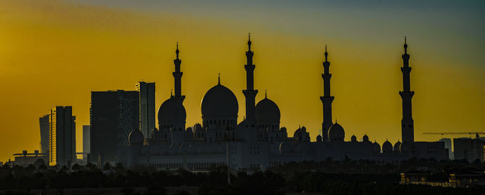 Panoramic view of buildings against sky during sunset