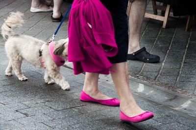 Low section of woman standing on sidewalk