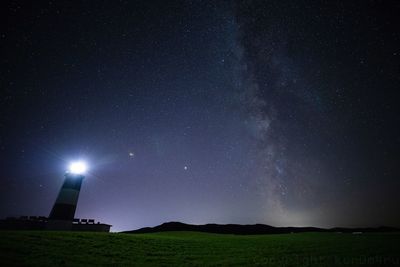Scenic view of illuminated star field against sky