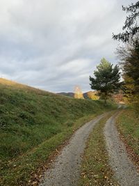 Empty road along countryside landscape