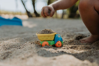 Close up child playing with sand