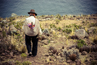 Rear view of man standing in water