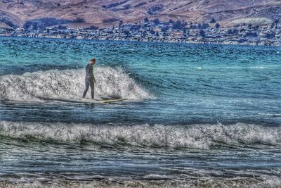Person surfing in sea
