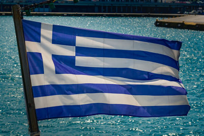 Close-up of flags against blue sea