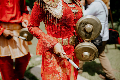 Midsection of woman holding telempong