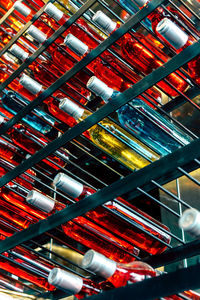 Full frame shot of drink in bottles on rack at store for sale