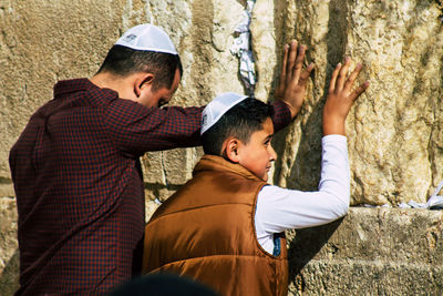 Rear view of man and friends on cross