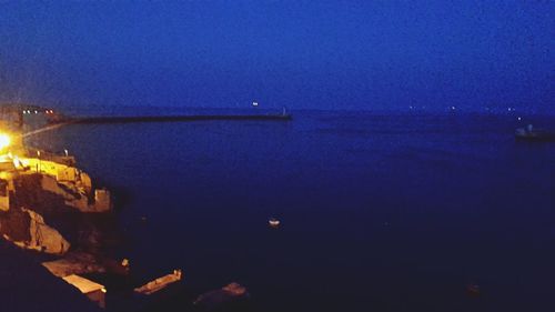 Scenic view of sea against clear sky at night