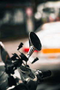 Close-up of bicycle on motor scooter