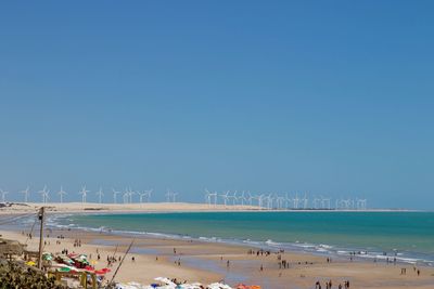 Scenic view of beach against clear blue sky