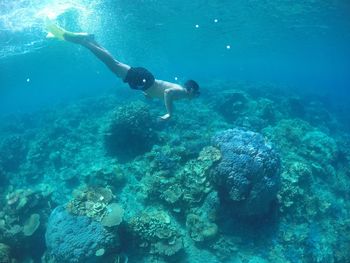 Shirtless man snorkeling in sea