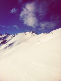 Scenic view of snow covered mountains against sky