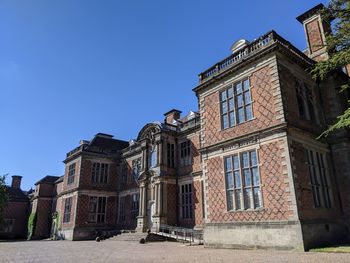 Low angle view of historic building against clear blue sky