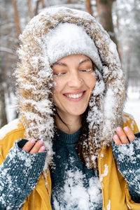 Portrait of a smiling young woman in snow