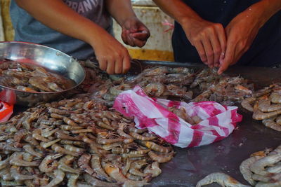 Midsection of man preparing food at market