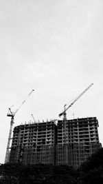 Low angle view of crane against clear sky