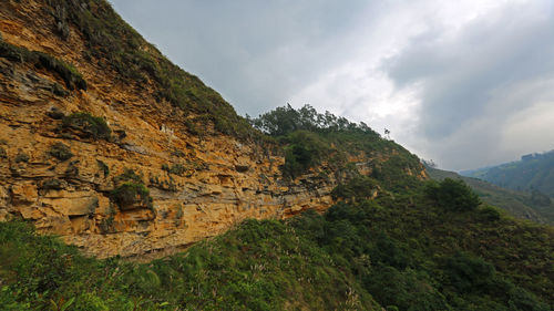 Scenic view of mountain against cloudy sky