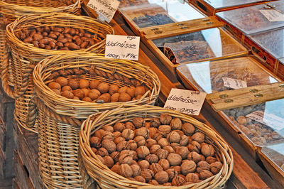 High angle view of walnuts in wicker basket at store for sale