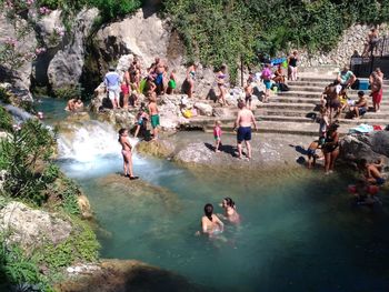 High angle view of people enjoying in water