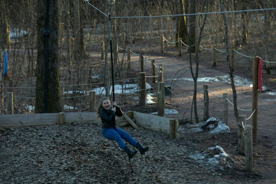 A girl rides a children's bungee in the park