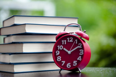 Close-up of clock on book