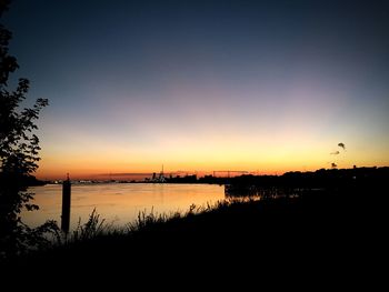 Scenic view of river against sky during sunset