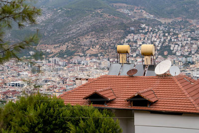 Barrels of water heated by solar batteries installed on roof of house. solar energy.