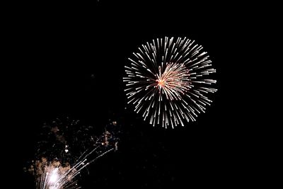 Low angle view of firework display at night