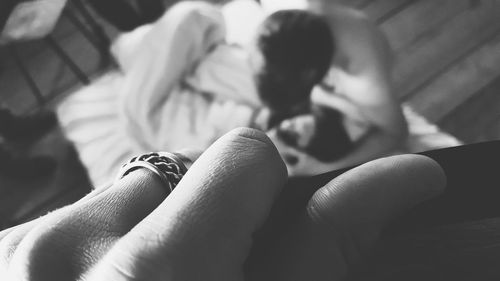 Midsection of woman with hands on bed
