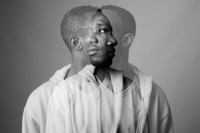 Portrait of young man against gray background