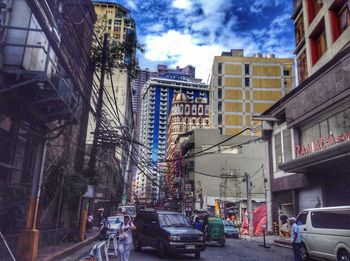 Cars on street amidst buildings in city