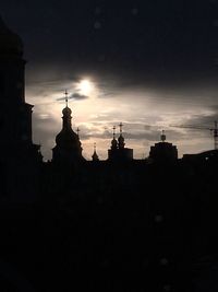 Silhouette city against sky during sunset