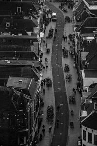 High angle view of crowd on road amidst buildings in city