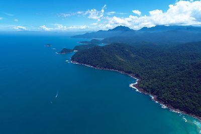 Aerial view of sea and mountains against sky