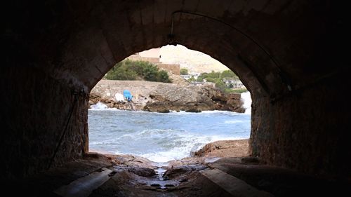 Scenic view of sea seen through tunnel