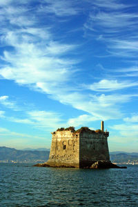 Castle by sea against sky