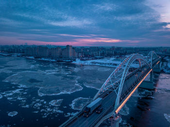 High angle view of bridge in city against sky at sunset