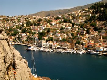 High angle view of townscape by sea against sky