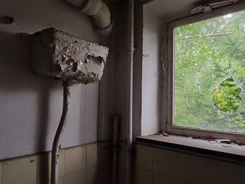 Damaged window in abandoned room
