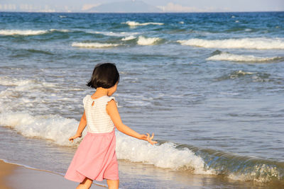 Full length of woman standing on beach