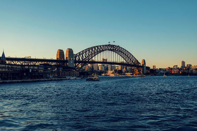 View of bridge over river with city in background