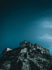 Low angle view of abandoned building against sky