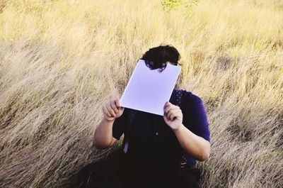 Man photographing through smart phone in land