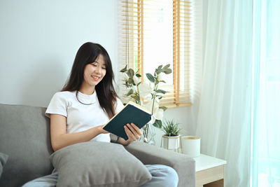Young woman using laptop at home