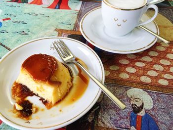 High angle view of caramel custard and coffee cup on table