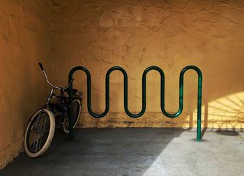 Bicycle parked against wall