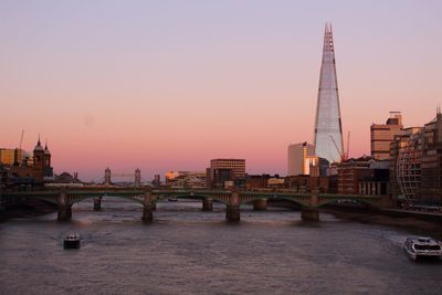 View of bridge and buildings against sky during sunset