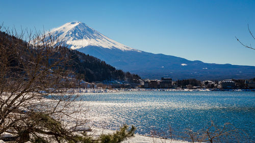 Scenic view of lake kawaguchi and mt fuji against blue sky during winter