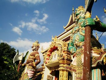Low angle view of statue in temple against sky
